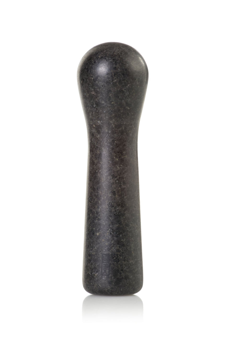 Dark, elongated stone pestle with a rounded top and slightly wider base.