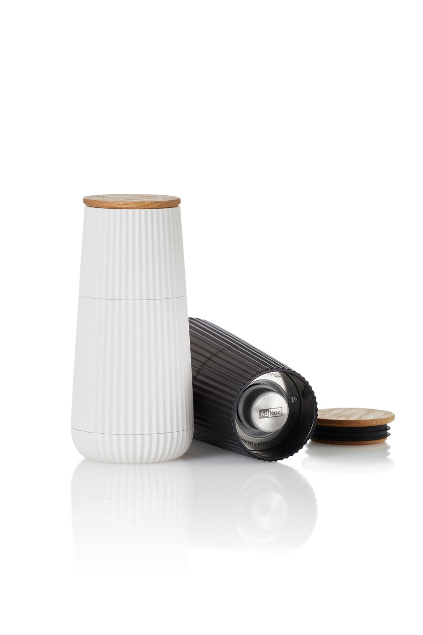 White ceramic container with a ribbed texture and wooden lid.