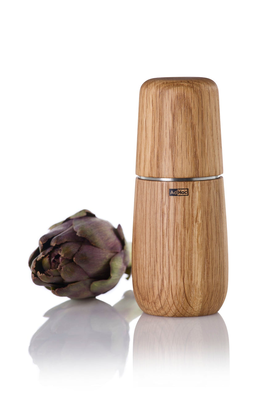 Wooden pepper mill or spice grinder with a smooth, cylindrical shape.