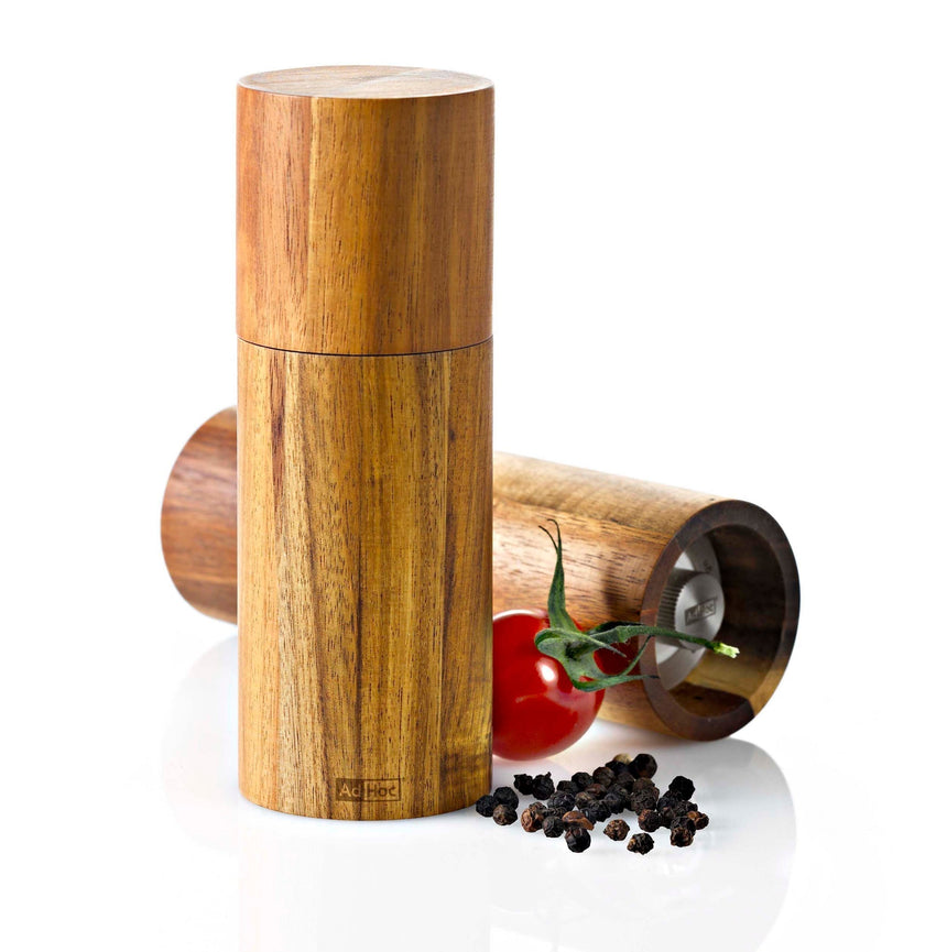 Wooden cylindrical pepper mill or grinder with a smooth, polished finish.