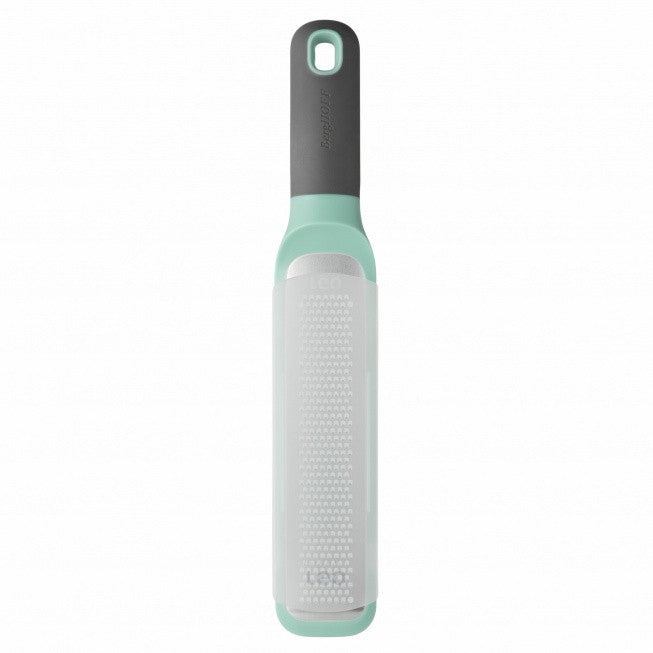 Mint green and white kitchen grater with a dark gray handle.
