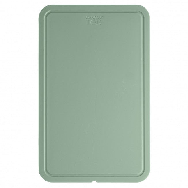 Mint green rectangular plastic cutting board with rounded corners and a raised edge.