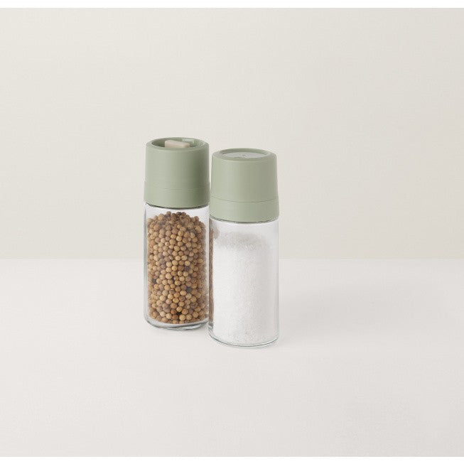 Salt and pepper shakers with pale green lids.