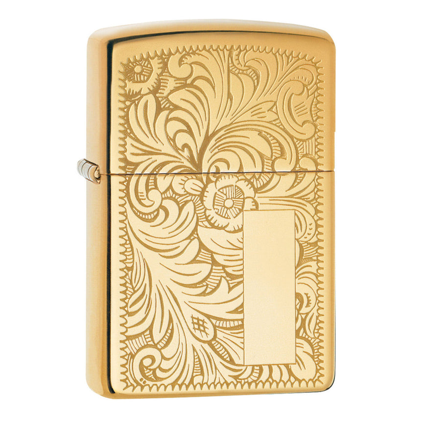 Gold-colored Zippo lighter with an ornate floral engraving pattern.