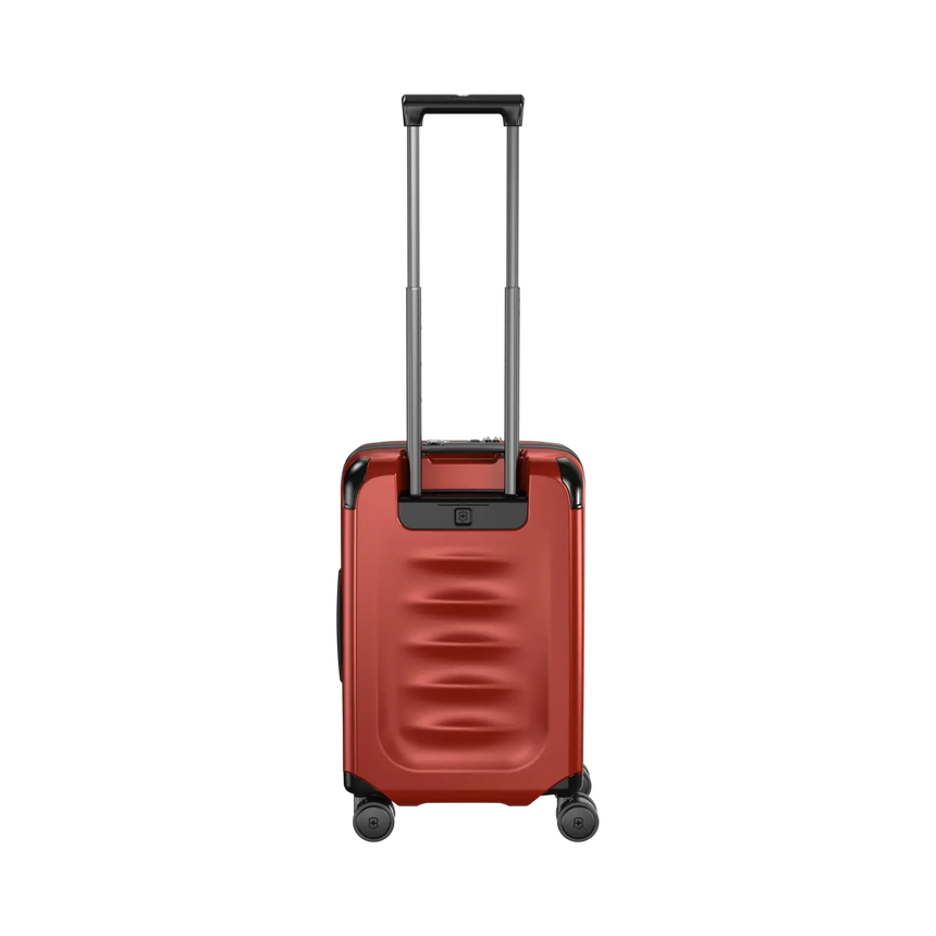 Red hardshell rolling suitcase with an extendable handle and wheels.