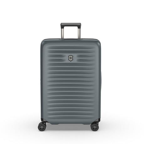 Gray hardshell rolling suitcase with horizontal ridges and a retractable handle.