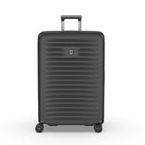 Black hardshell rolling suitcase with horizontal ridges and a retractable handle.