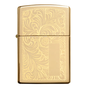 Gold-colored Zippo lighter with an ornate floral engraving pattern.