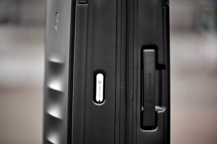 Close-up view of a black suitcase or luggage handle.