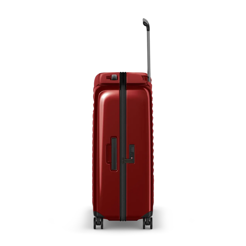 Red hardshell rolling suitcase with a telescoping handle and wheels.