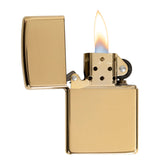 Gold-colored metal lighter with an open lid and lit flame.