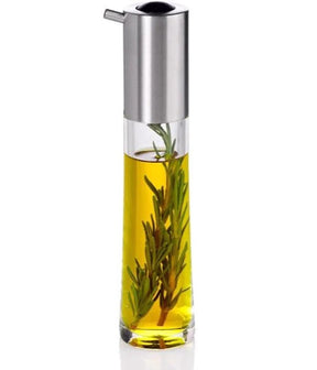 Oil dispenser with herbs infusing in yellow oil and a stainless steel pouring spout.