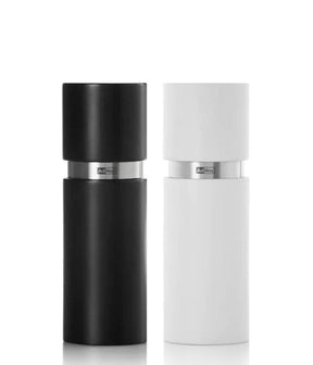 Pair of cylindrical salt and pepper grinders in black and white.