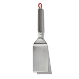 Stainless steel spatula with a red hanging loop on the handle.