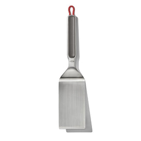 Stainless steel spatula with a red hanging loop on the handle.