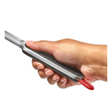 Hair straightener or flat iron being held in a hand.