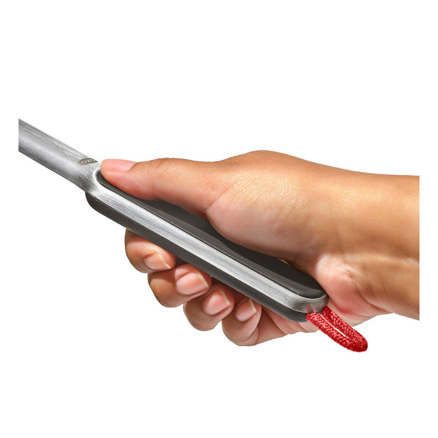 Hair straightener or flat iron being held in a hand.
