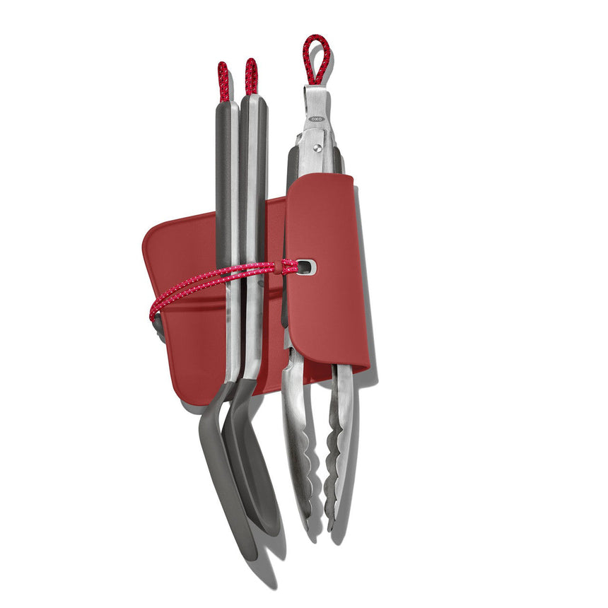 Compact set of kitchen utensils with red handles and storage holder.