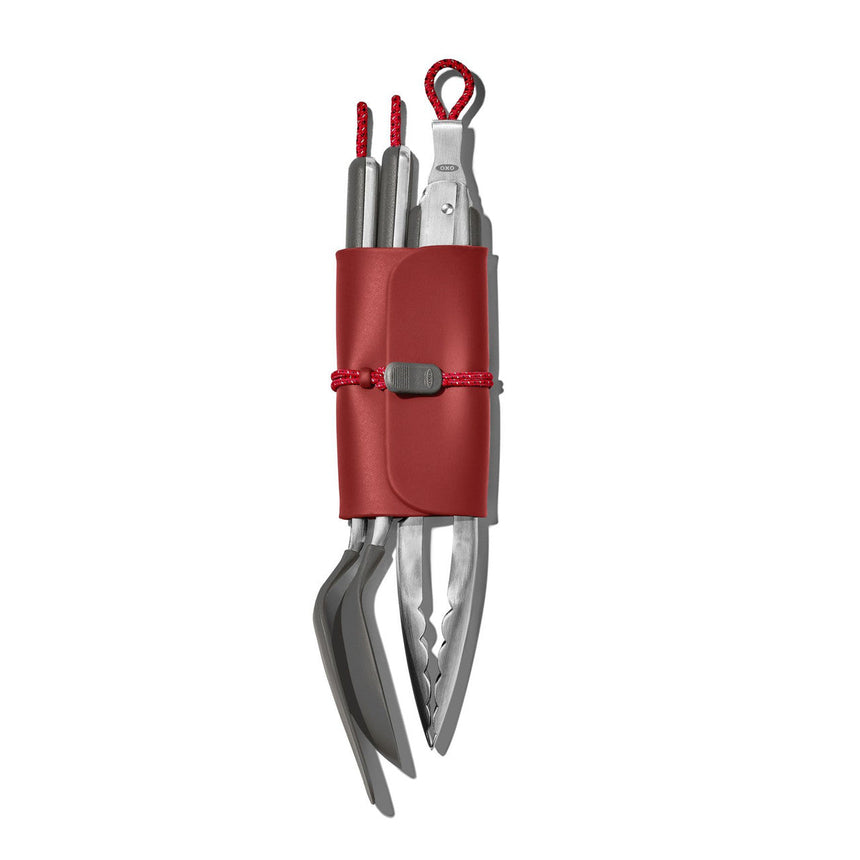 Compact multi-tool with red handle and folded metal implements.