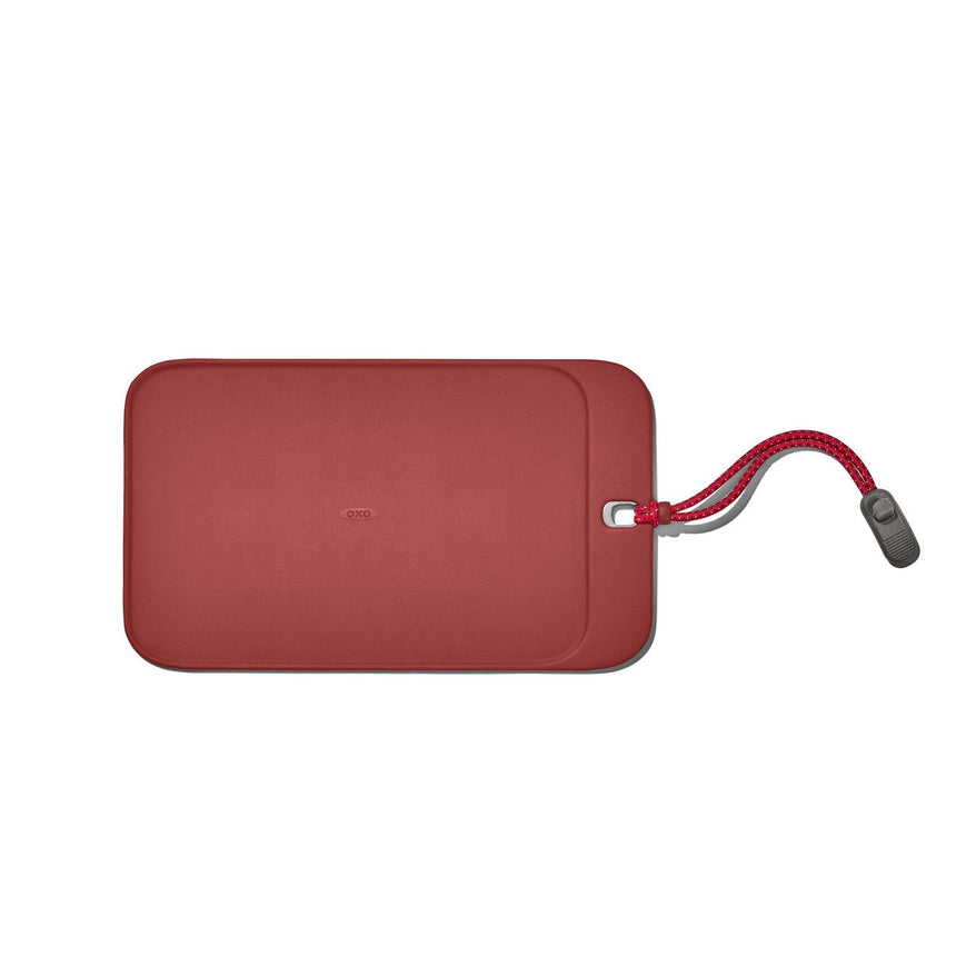 Red rectangular luggage tag with a cord attached.