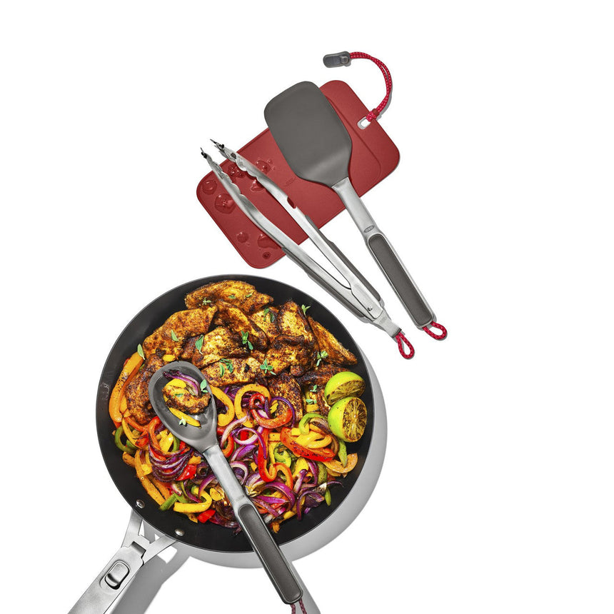Frying pan filled with colorful grilled vegetables and meat.