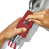 Red smartphone case with a wrist strap being held by hands.