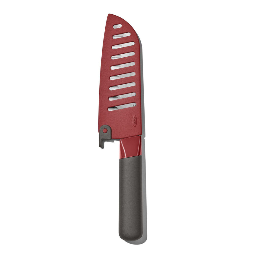 Red kitchen knife with a slotted blade and gray handle.