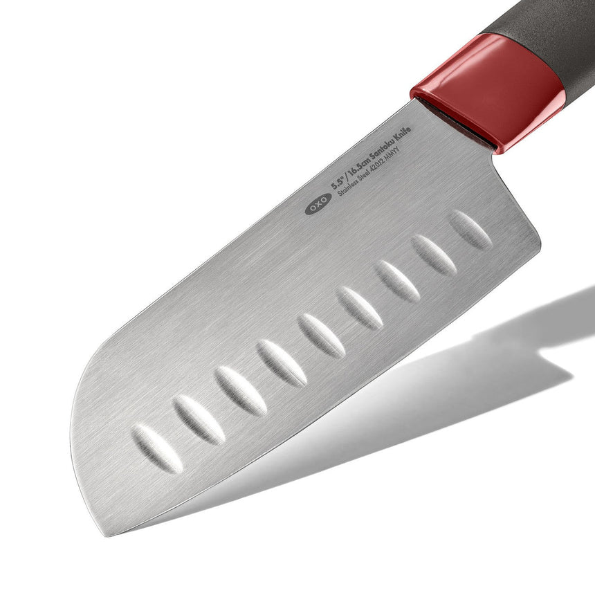 Santoku knife with a stainless steel blade and red-accented handle.