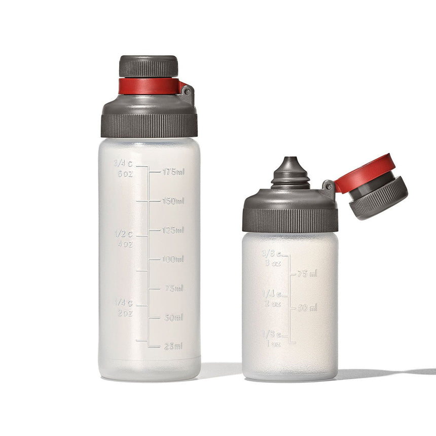 Two reusable water bottles with measurement markings and gray/red caps.