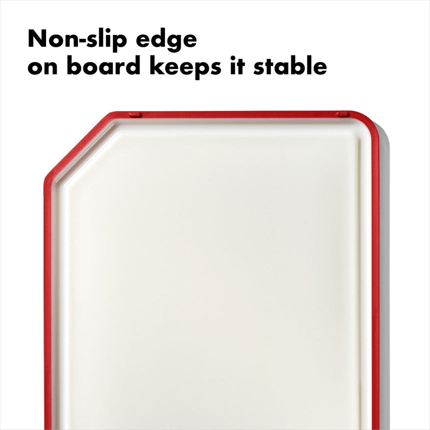 White cutting board with a red non-slip edge.