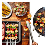 Assortment of grilled foods including corn, shrimp skewers, vegetable kebabs, and a fresh salad.