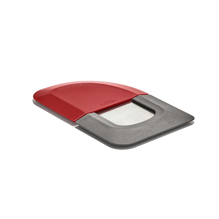 Red and gray cutting board with a sliding compartment.
