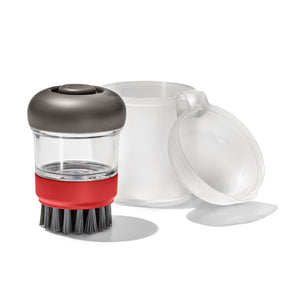 Soap-dispensing dish brush with a clear container and red accent band.