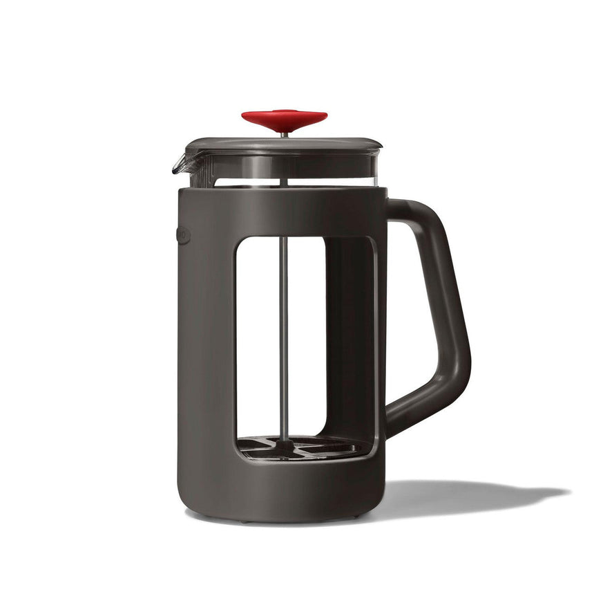 French press coffee maker with a dark gray body and red lid.