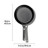 Black frying pan with a long handle.