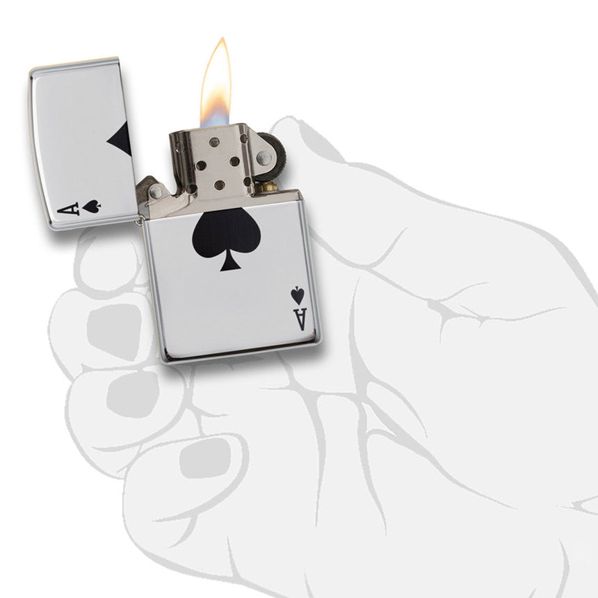 Lit metal lighter with an ace of spades design on its side.