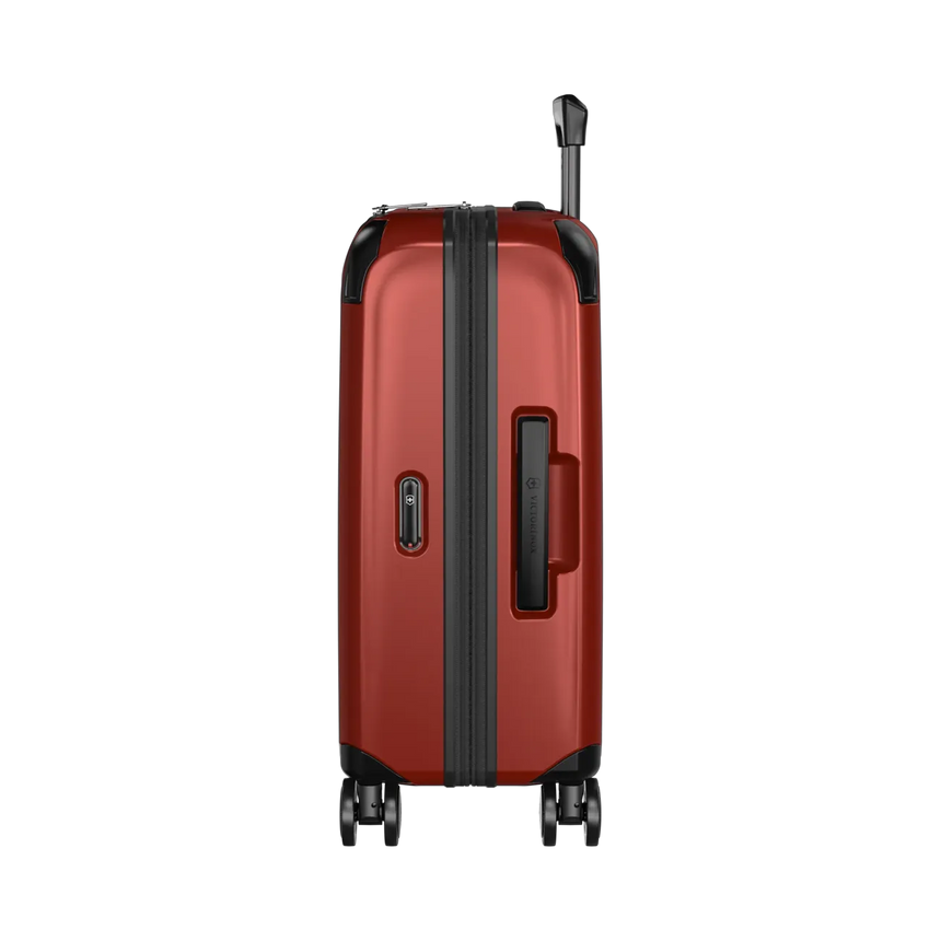 Red hardshell rolling suitcase with black trim and wheels.