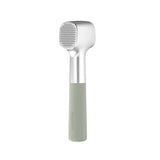 Handheld meat tenderizer with a silver head and light green handle.