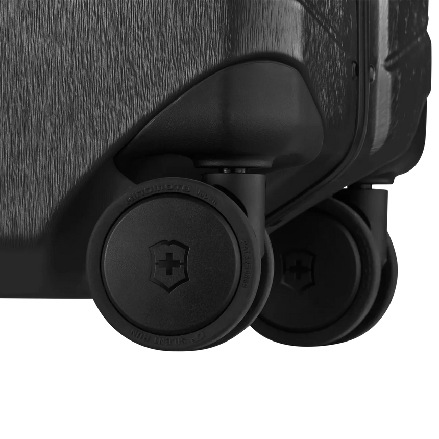 Luggage wheels attached to the bottom corner of a suitcase.