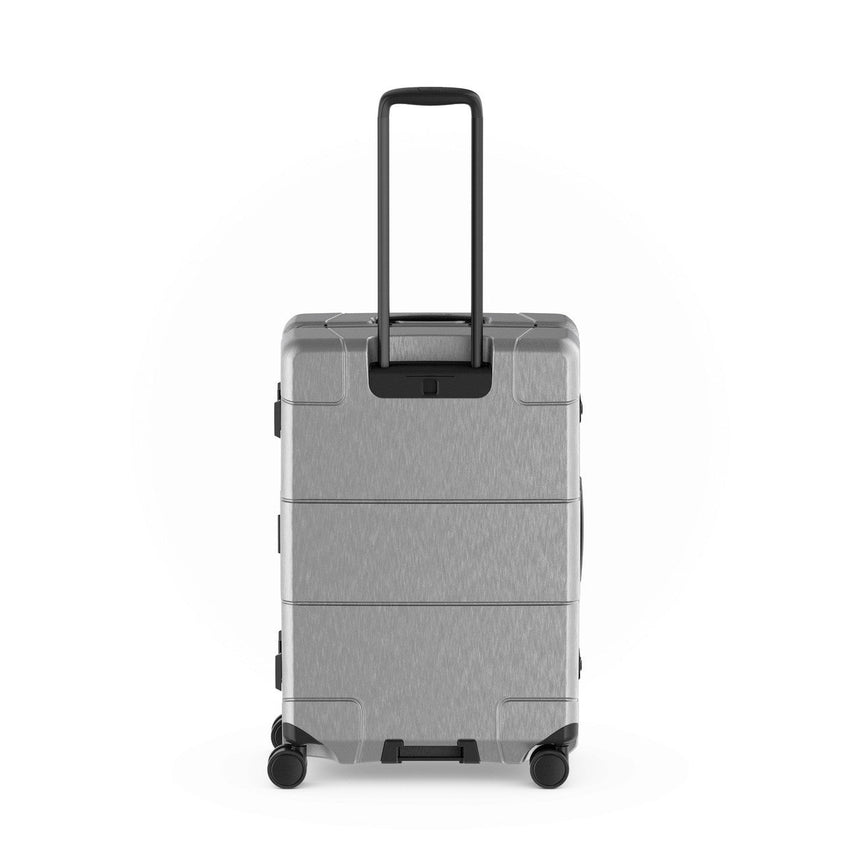 Gray hardshell rolling suitcase with an extendable handle and wheels.