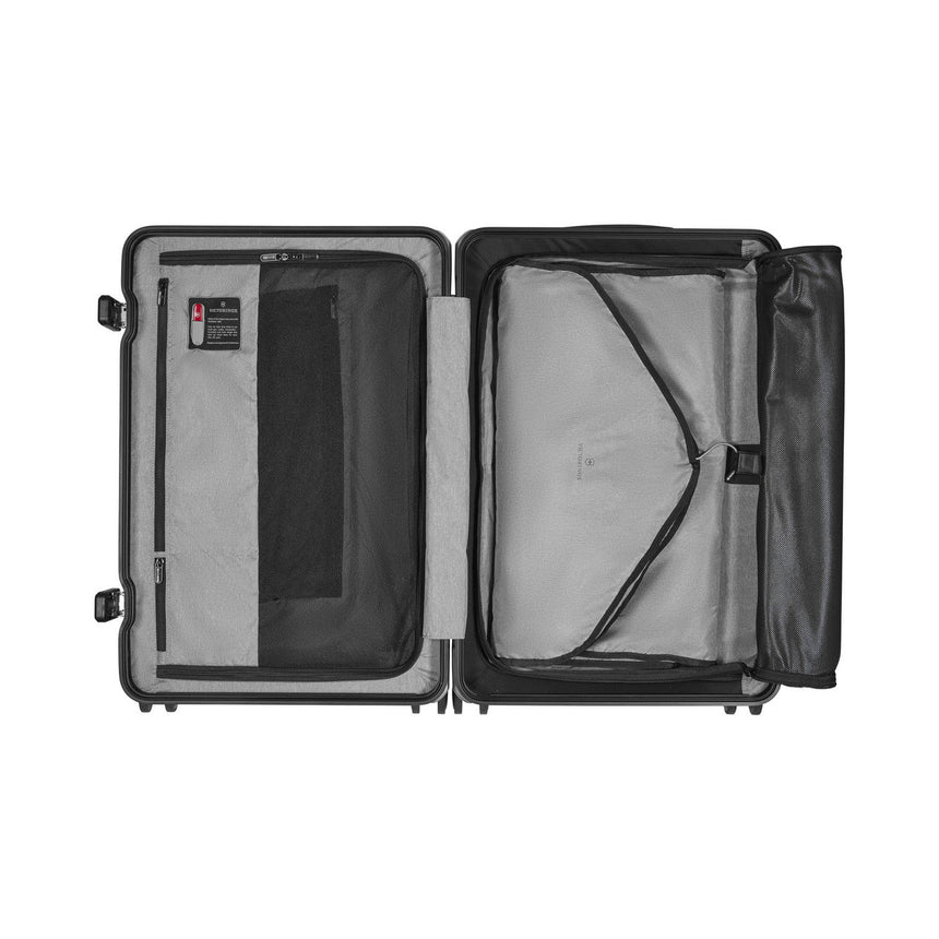 Open suitcase with compartments and straps for organizing contents.