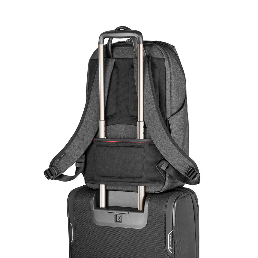 Backpack with a luggage handle pass-through sleeve on the back.