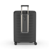 Hard-shell rolling suitcase with horizontal ridges and an extendable handle.