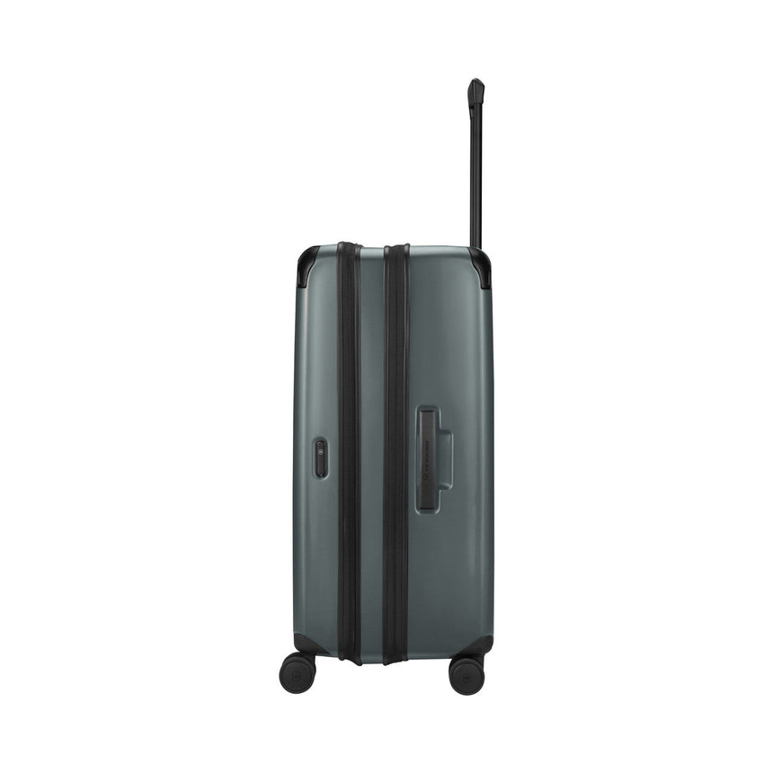 Gray hardshell rolling suitcase with an extendable handle and wheels.