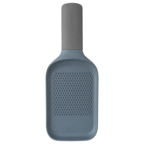 Bottle-shaped grater with a textured surface and cylindrical neck.
