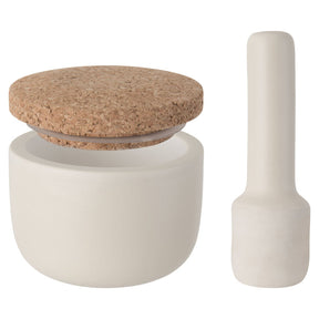 White ceramic mortar and pestle set with a cork lid on the mortar.