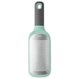 Mint green and gray handheld cheese grater with a perforated metal surface.