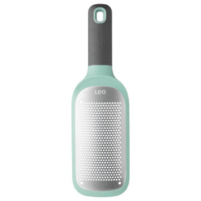 Mint green and gray handheld cheese grater with a perforated metal surface.