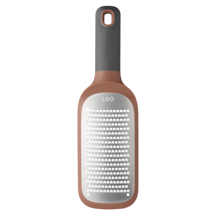 Kitchen grater with a rose gold-colored handle and gray grating surface.