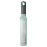 Mint green and gray kitchen grater with a long handle.